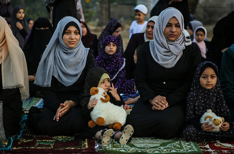 Palestinian children attend prayers during the Eid al-Adha festival in Gaza.
Eid al-Adha is the biggest celebration for Muslims in all over the world after Eid al-Fitr to commemorate the willingness of Ibrahim (also known as Abraham) to follow Allah's (God's) command to sacrifice his son.