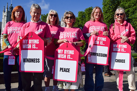 Supporters of the Assisted Dying Bill hold placards during a demonstration in Parliament Square as Members of Parliament debate changes to the bill.