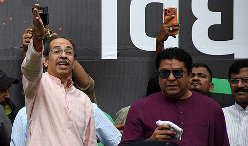 Indian politician and Shiv Sena's (UBT) chief Uddhav Thackeray (L) gestures with his hand as founder and chairman of Maharashtra Navnirman Sena (MNS) Raj Thackeray (R) looks on during the celebration held after the resignation of Union Education Minister Dharmendra Pradhan. Youth led Cockroach Janata Party (CJP) protest which lasted for 36 days concluded on July 25 2026 after the government accepted the key demands put forth by leaders of Cockroach Janata Party (CJP) alongside resignation of Union Education Minister Dharmendra Pradhan in alleged paper leaks and irregularities found in major national medical entrance examinations.