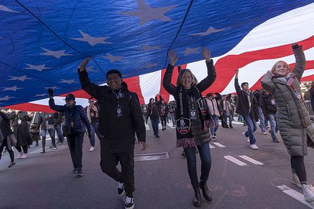 NEW YORK, NEW YORK - NOVEMBER 11: Members of Wounded Warrior Project with a large Stars and Stripes participate in the annual Veterans Day Parade on November 11, 2023 in New York City. Hundreds of people lined 5th Avenue to watch the biggest Veterans Day parade in the United States. This year's event included veterans, active soldiers, police officers, firefighters, and dozens of school groups participating in the parade which honors the men and women who have served and sacrificed for the country.
