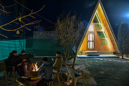 Residents gather around the bonfire during a cold winter evening on the outskirts of Srinagar, the summer capital of Jammu and Kashmir.