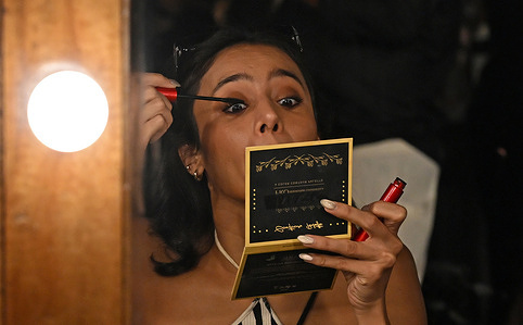 A model is seen doing her makeup inside the makeup room at the Lakme Fashion Week (LFW) in Mumbai.