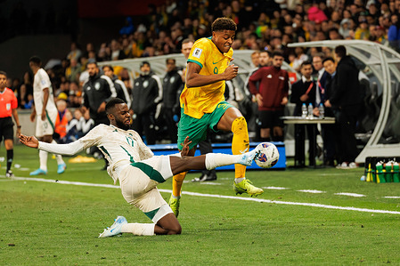 Kusini Yengi of Australia (R) and with Hassan Al Tambakti of Saudi Arabia (L) seen in action during the third round of the FIFA World Cup 2026 Qualifier match between Australia Socceroos and Saudi Arabia at Melbourne Rectangular Stadium. Final score; Australia 0:0 Saudi Arabia