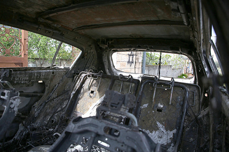 A car seen burned down with an Israeli Star of David painted next to it after an attack by Jewish settlers. The Israeli military accuses Palestinians of killing the shepherd. Jewish settlers attacked the village of Deir al-Hatab, setting fire on homes, vehicles, writing Hebrew slogans on walls, and calling for revenge. Six Palestinians were injured after the funeral of the Jewish shepherd from the Elon Moreh settlement.