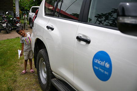 A child plays next to a UNICEF vehicle. UNICEF supports children’s rights in Bangladesh by improving education, health, nutrition, water and sanitation, and child protection. It also provides emergency aid, especially for Rohingya refugees, and works closely with the government to build a safer future for every child.