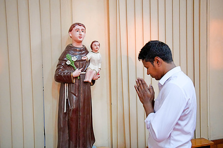 A Christian prays in a church in Bogura.