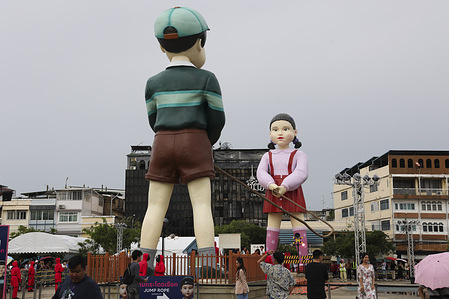 The 12 meter-tall art installation of "Younghee" and "Cheolsu”, the iconic doll character from the popular Netflix South Korean TV series "Squid Game" is displayed during a themed event at City Hall Square in Bangkok. The Bangkok Metropolitan Administration (BMA) is hosting a Squid Game themed event at City Hall Square to celebrate the final season of the Netflix series.