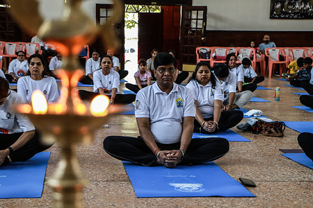 People participate in a Yoga session during the celebration of International Yoga Day at the Raghuvansh Bhavan Centre in Nakuru City.