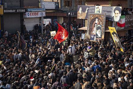 People gather at the Clock Tower in Lal Chowk, holding photographs of Ayatollah Ali Khamenei and Islamic flags during a mourning march. Thousands of protesters took to the streets across parts of Kashmir following reports of the assassination of Iran’s Supreme Leader, Ayatollah Ali Khamenei. Demonstrators, many carrying his photographs and raising anti-U.S. and anti-Israel slogans, marched through towns amid tight security. Religious leaders and community members condemned the killing, calling it an attack on the Muslim world, as authorities monitored rallies to prevent unrest.