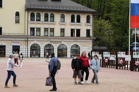 Russian Federation. Krasnodarskiy kray. Sochi, Rosa Khutor. Rosa Dolina. Spring, May. Tourists in the Rose Valley, on the first level of the Rosa Khutor resort.