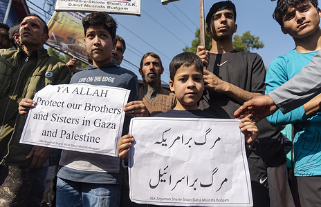 Muslim kids hold placards during a protest in solidarity with Palestine in Budgam. Protesters staged a rally in Budgam in a strong show of solidarity with Palestine on Friday, amid flared-up tensions between Israel and Hamas. More than 2,700 people have been killed since the outbreak of the conflict on Saturday, 1,400 Palestinians and 1,300 Israelis.
