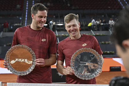 Harri Heliovaara of Finland and Henry Patten of Great Britain pose for a photo with their trophies following their victory against Manuel Guinard of France and Guido Andreozzi of Argentina (not in view) during the Men's Doubles Final of Mutua Madrid Open 2026 at La Caja Magica. Victiry Harri Heliovaara and Henry Patten of 3-6, 6-3, 7-10