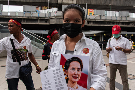 A Myanmar migrant group member holds a portrait of Aung San Suu Kyi during the protest to mark the international labor day. Myanmar migrant group held a demonstration in Bangkok to mark the International Labor Day and calling for the workers rights against the Myanmar military government.