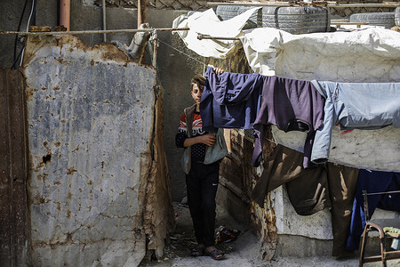 A Palestinian boy stands outside their home at Shati refugee camp in the western Gaza Strip.