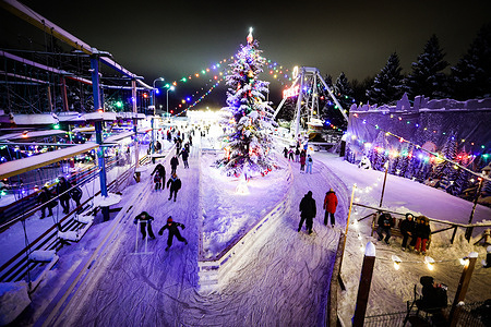People skate on a rink near the Christmas tree at Yuzhno-Primorsky Park in St. Petersburg.