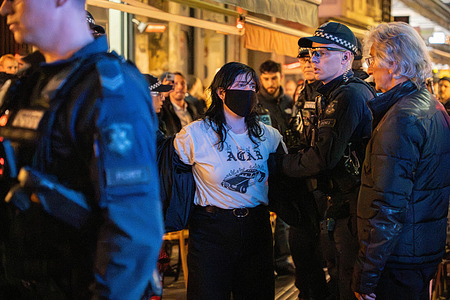 A protester is being arrested by police officers. A Melbourne restaurant 'Miznon' whose owner has ties to the controversial Gaza Humanitarian Fund aid group became a crime scene as anti-Israeli protesters knocked over tables, smashed plates, bottles and glass. The police intervened and many protesters were arrested.