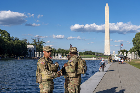 National Guard troops stand guard over paint peeling off the bottom of the reflecting pool, Friday, June 19, 2026, in Washington.