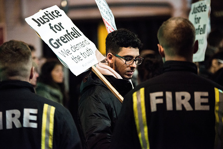 Firefighters seen holding a placard bearing the slogan 'Justice for Grenfell' during the monthly silent march for the Grenfell Tower fire victims.
Around 1,000 people joined the monthly silent march at night to commemorate the victims of the Grenfell Tower fire. The march marks five months since the June 14 fire, which spread ferociously through the 24-storey west London block and killed 80 people.