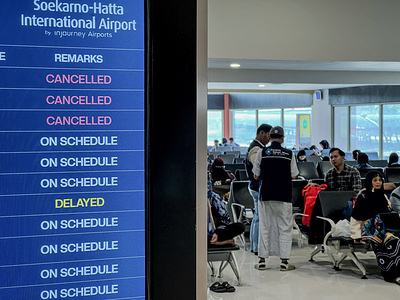 Umrah pilgrims wait for their departure in the waiting area at Soekarno-Hatta Airport. The eruption of Mount Anak Krakatau forced airport authorities to temporarily suspend operations at Soekarno-Hatta Airport until 9:30 a.m. WIB, leading to the cancellation of 209 domestic and international flights.