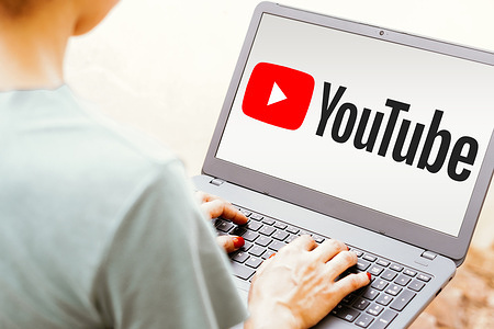 In this photo illustration, the YouTube logo is seen displayed on a laptop screen.