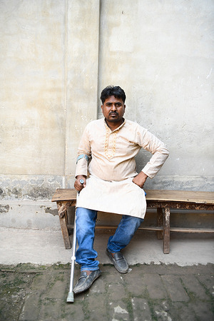 Rana Plaza collapse survivor Mahmudul Hasan Hridoy poses for a portrait with his injured leg. He sustained his injury when Rana Plaza collapsed in 2013. Ten years ago on April 24th, 2013, the world witnessed one of the worst industrial disasters in history when the Rana Plaza building in Bangladesh collapsed, killing more than 1,100 people and injuring 2500 others. The tragedy sent shockwaves around the globe and sparked concerns about the unsafe working conditions in Bangladesh's booming Ready-Made Garment (RMG) sector. The eight-story building housed several factories that produced clothing for global brands such as Primark, Mango, and Benetton. The building's collapse was a stark reminder of the human cost of fast fashion and brought to light the terrible working conditions endured by many of the country's garment workers.