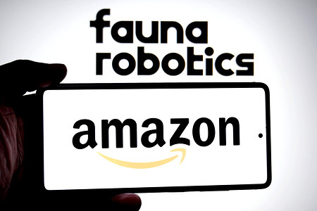 In this photo illustration, an Amazon logo is seen displayed on a smartphone with a Fauna Robotics logo in the background.