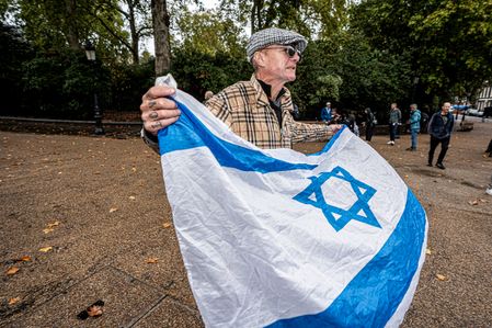 A old man seen holding a flag (Israeli flag) during the protest . Pro-Palestine activists from Central London Universities chose the 3rd anniversary of the October 7th attack by Hamas to protest against Israel’s war on Gaza. They clashed en route with pro-Israeli counter-protesters. The demonstration was arranged by an inter-uni coalition that includes King’s College and the London School of Economics and Political Science (LSE).