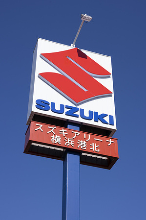 The Suzuki company logo at a Suzuki dealership in Yokohama. Suzuki Motor Corporation has achieved notable success in selling cars abroad recently, particularly through its strong focus on compact, affordable, and fuel-efficient models that appeal to emerging and price-sensitive markets.Models like the Swift have been global hits, reaching 10 million cumulative sales worldwide by 2025, with 60% in India alone, followed by Europe (14%) and other regions. Suzuki's overseas sales often outpace domestic Japanese figures, contributing to global totals around 3 million+ vehicles annually (e.g., record highs in certain months of 2025 driven by India and other markets). This export strength highlights Suzuki's strategy of leveraging cost-effective manufacturing (especially in India) to penetrate developing regions and expand into EVs for developed markets.