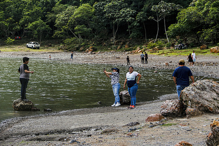 Tourists enjoy the Alegría Lagoon in the crater of the Tecapa Volcano.