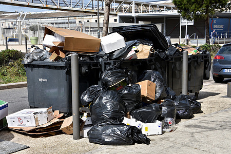 Rubbish is left on the ground next to full trash containers in Marseille. Marseille garbage collectors are on strike to protest against the pension reform.