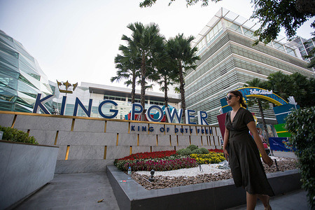 A young lady seen walking front of the King Power logo at the King Power Headquarter in Central Bangkok. 
Thai billionaire Vichai Srivaddhanaprabha, Chairman of King Power died in a helicopter crash among four other people in the Premier League side's stadium car park on October 27, 2018 in Leicester City in the United Kingdom.