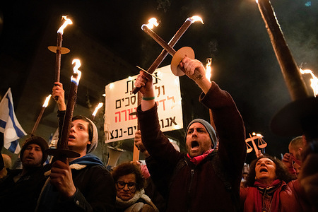 Protesters hold burning torches during the demonstration. Hundreds demonstrated against the new Israeli right-wing government and judicial overhaul in Jerusalem.