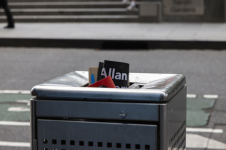 A discarded placard is seen in a bin with the only text visible being "Allan" in reference to the Allan government during a demonstration outside parliment. Education workers attend a strike rally in Melbourne, Australia, as teachers and support staff walk off the job across Victoria to protest working conditions and pay during ongoing negotiations between the Australian Education Union (AEU) and the Victorian Government.