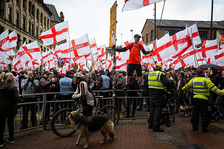 A man flying a st Georges flag joins the Britain First march for St. George's Day. Hundreds of people joined Paul Golding to parade around the city centre. They were met with a counter-protest by anti-racism groups and trade unions opposing the movement due to the party's rhetoric on immigration.