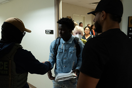 A young man is stopped and detained by Federal agents at the Executive Office of Immigration Review (EOIR) courts in 26 Federal Plaza.