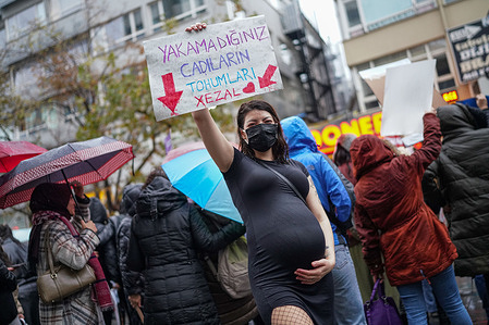 A pregnant woman holds a placard saying "The seed of witches you can't burn" during a protest. In Ankara, feminist women's organizations organized a protest on Sakarya Street on the occasion of the International Day for the Elimination of Violence Against Women.
