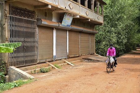 HOOGHLY, INDIA - APRIL 22, 2020:
A cyclist wearing a face mask as a preventive measure against the spread of coronavirus rides past closed shops during the lockdown.
India has reported 652 deaths and crossed 20000 confirmed cases of the COVID-19 coronavirus so far.