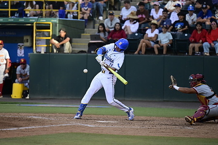 Outfielder Payton Brennan (11) of the UCLA Bruins hits the ball during the 3rd game of the series against the USC Trojans a NCAA baseball game at Jackie Robinson Stadium
