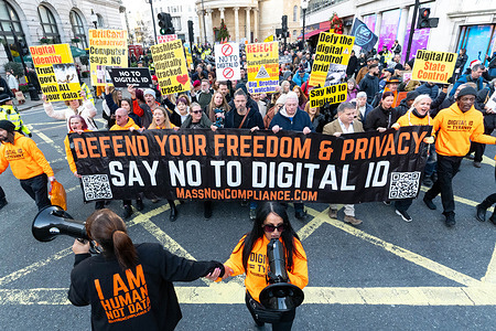 Protesters march with placards and a banner saying "Defend your freedom and privacy. Say no to digital ID" during the demonstration. Protesters marched from BBC headquarters in Portland Place through central London to oppose the government’s proposed mandatory digital ID scheme, warning it threatens privacy, freedom, and civil liberties. The demonstration brought together a cross-section of citizens demanding that identity not become a tool of surveillance, data control, and state overreach.