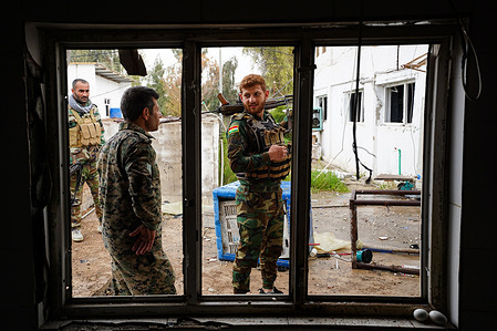 Kurdish fighters and members of the Khabat Organization of Iranian Kurdistan (Sazmani Khabat) examine the area affected by the Iranian drone strike at their base near Erbil, the capital of the Kurdistan Region of Iraq. Kurdish opposition fighters opposed to the Iranian regime have faced repeated missile and drone attacks from Iran in recent weeks amid the ongoing conflict involving the United States, Israel, and Iran. According to a member of the Khabat Organization of Iranian Kurdistan (Sazmani Khabat), a base was targeted by drones on March 13, killing two members and injuring four others at another military site.