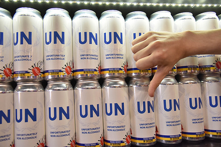A man shows a "dislike" gesture against the background of cans of beer with the inscription UN (Unfortunately non-alcoholic), created by the Lviv brewery "Truth" to demonstrate the inaction of the United Nations in Russia's war with Ukraine. This is the first non-alcoholic beer of Pravda brewery. The beer can contain the symbols of the UN (United Nations) and means the name Unfortunately non-alcoholic. Thus, the owners of the brewery emphasize that the organization "is not very successful in achieving the goals for which it was created." The name of the beer Unfortunately non-alcoholic hints at the inaction of the international organization in the war between Russia and Ukraine.