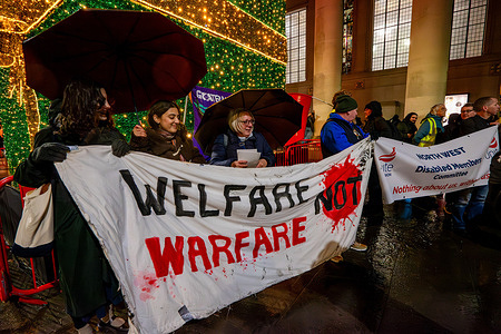 Protesters hold banners during the demonstration. Demonstration held in Manchester aimed to send a message to the government on Budget Day. Protesters said it reflected the anger and frustration of thousands. Approximately fifty people gathered from Unite, Unison and other trade unions at St Peter's square.