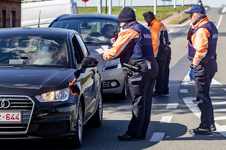 Border police officers inspecting vehicles at a check point.
Border authorities crack down on unnecessary crossings into Belgium from France and the Netherlands amid the new coronavirus (Covid-19) pandemic. The governor of West Flanders said police would double down on checks to ensure that only people come to Belgium for essential reasons are allowed in.