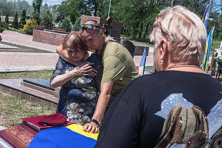 Relatives attend to the funeral of Roman Godina, a 39-year-old Ukrainian soldier from the Taras Seniuk Battalion, who was killed in action in 2024. The funeral service for Ukrainian soldier Roman Godina was held in Slovyansk on June 20, 2026, two years after his death in 2024. The delay reflected the challenges of recovering and identifying the remains of soldiers amid ongoing fighting, including prolonged recovery operations and mandatory forensic identification procedures.