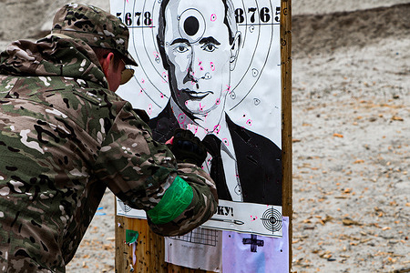 Ukrainian civilian checks his hit on the portrait of Russian President Vladimir Putin that serves as a shooting target. Ukrainian civilians are taking courses in military tactics at the territorial defense center on Kyiv's outskirts to defend their country from the Russian invaders. Different people, including pensioners and women, are joining the drills. They still wanted to prepare for the worst, although normality is slowly coming back.