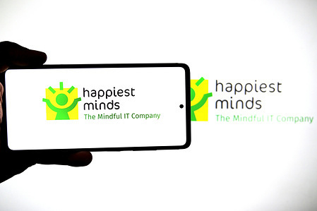 In this photo illustration, the Happiest Mind Technology logo is seen displayed on a smartphone and in the background.