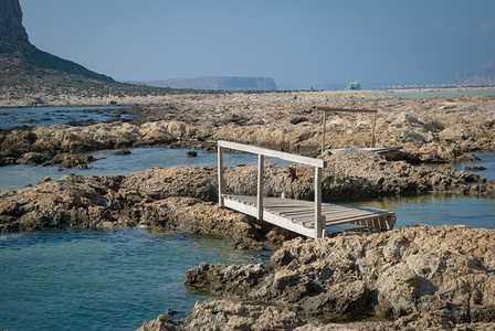 A small wooden bridge seen at Balos beach which has beautiful blue water color and is one of the biggest tourist destinations in Crete.