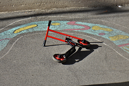 Child's scooter abandoned in a deserted schoolyard. Child's scooter in a schoolyard in Marseille, France.