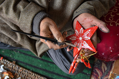 A Kashmiri artisan paints a Christmas gift made from papier-mache at a workshop ahead of Christmas celebrations. Christmas items are made from paper-mache and are sent to local markets and they are also exported to the U.S, Italy and many other parts of the world. Kashmiri paper-mache artisans are facing one of their bleakest seasons in decades. New U.S. tariffs on Indian imports have severely hit their largest export market, triggering order cancellations from the U.S. and Europe.