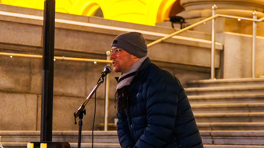 A supporter speaks about insecurity residing in Canada, after the incidents with ICE agents across the US, as temperatures fall below -10 Celcius. Organized by the Canadian Federation of Nursing Unions, the Edmonton Vigil was also supported by the United Nurses of Alberta. During the ceremony the names of 8 victims were read out.
